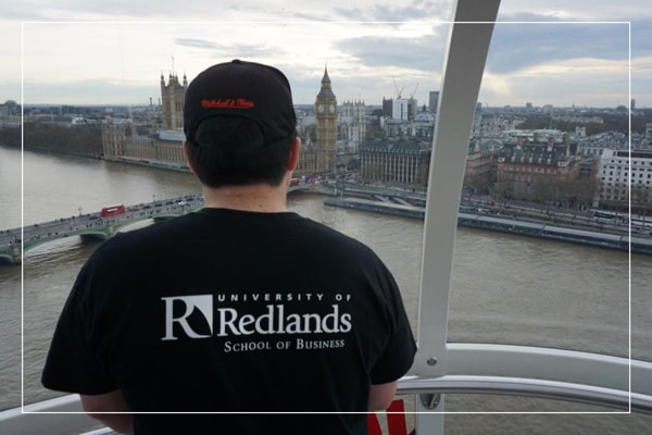Man in Redlands t-shirt on the London Eye, looking out at Big Ben
