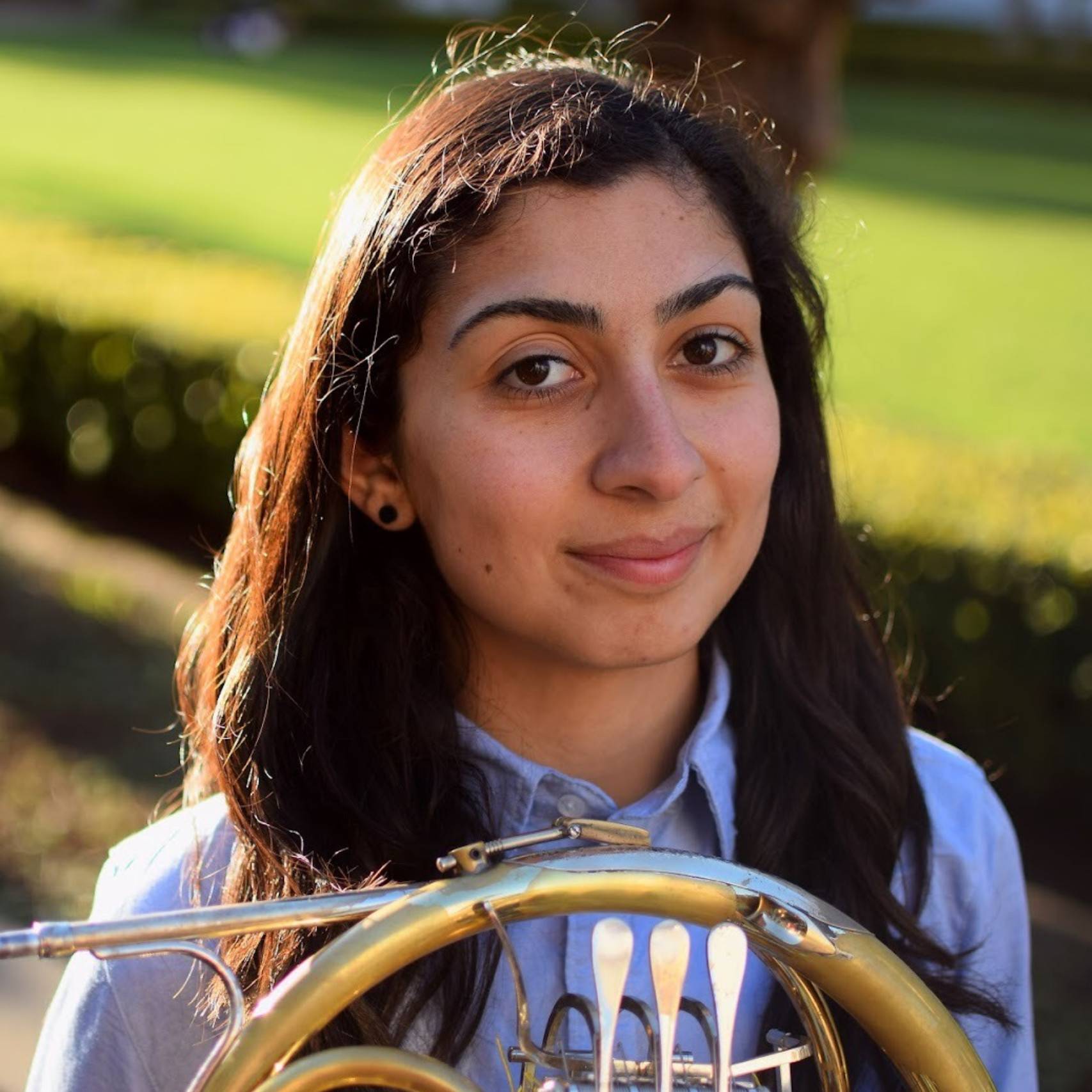 a person holding a french horn