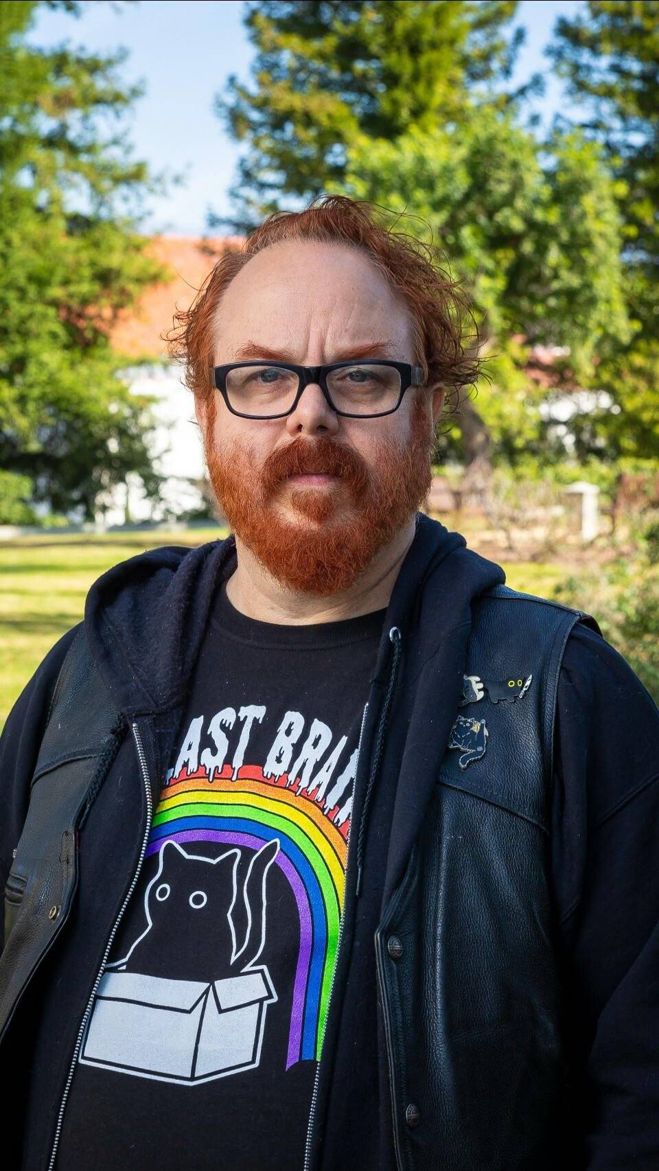 a person with red hair and beard wearing glasses