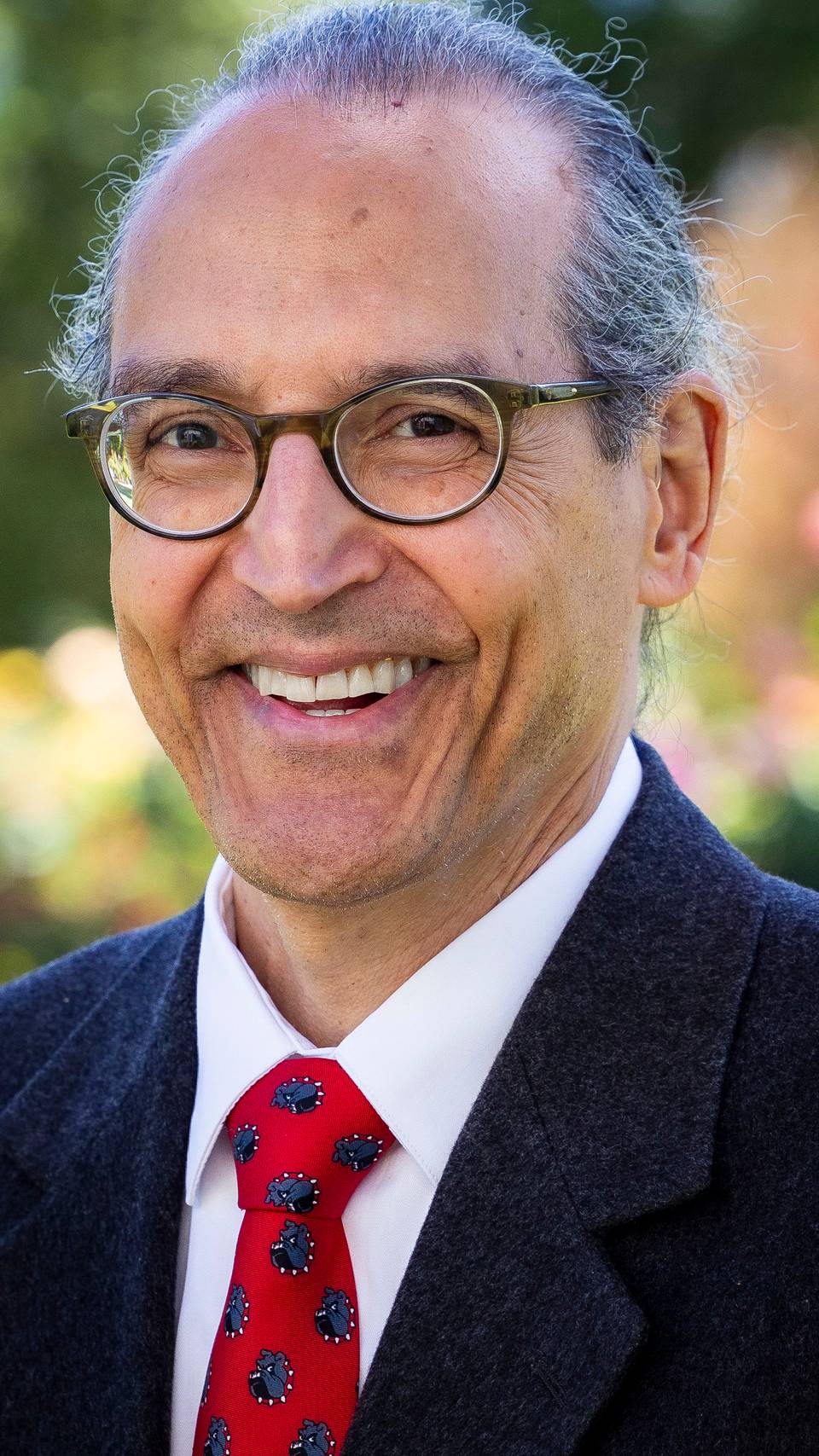 a person wearing glasses and a suit