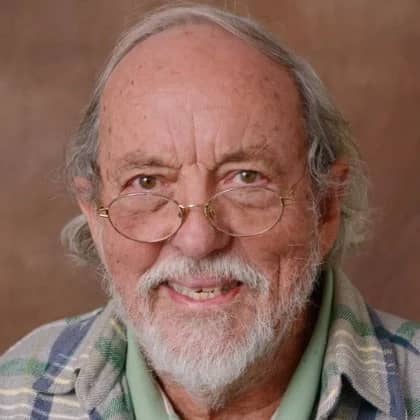 a person with glasses smiling