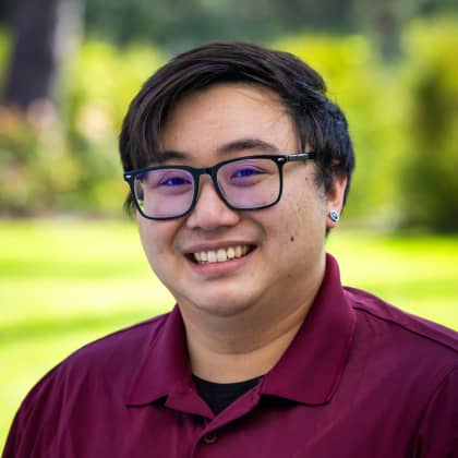 a person wearing glasses and smiling