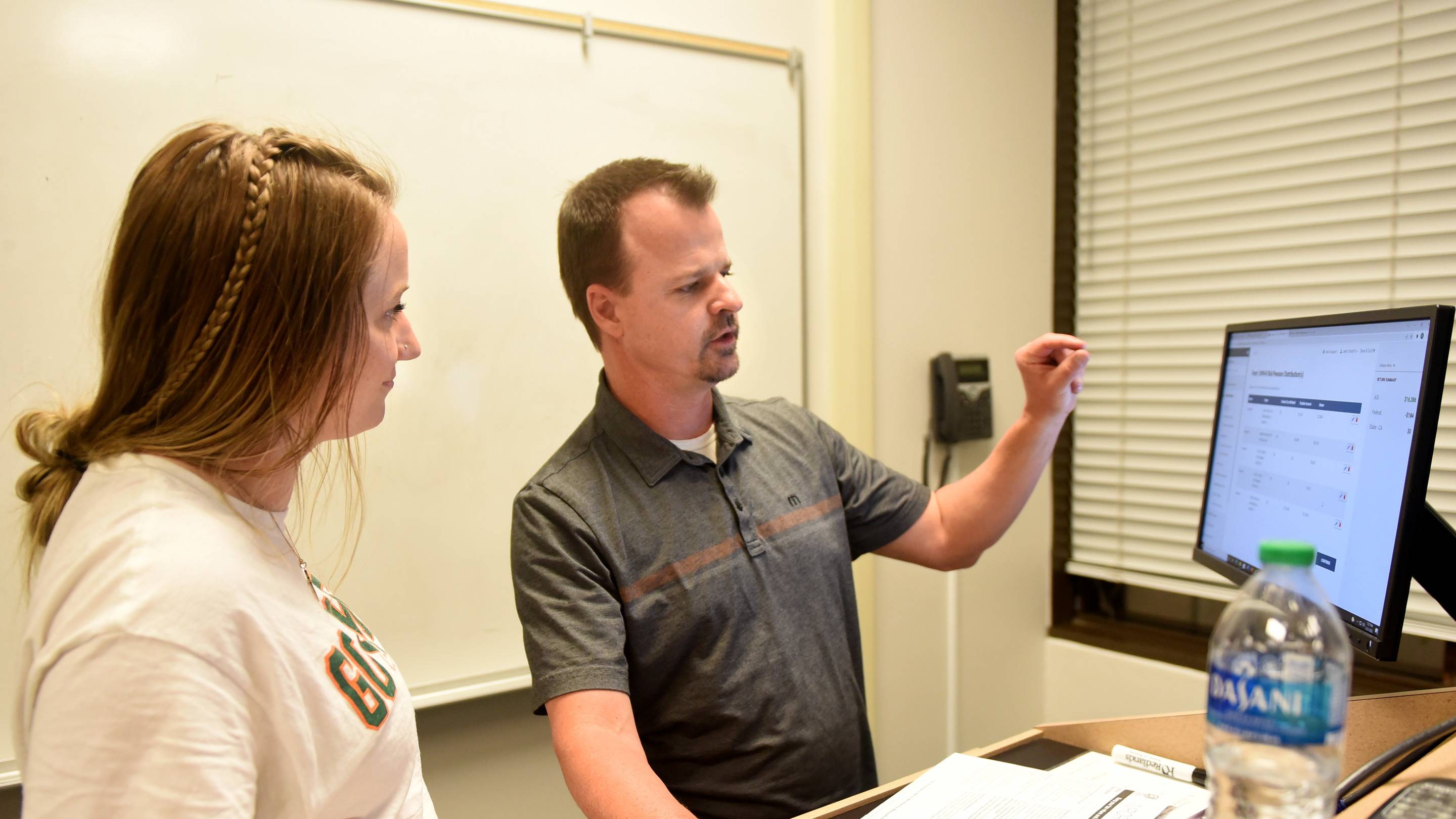 a person pointing at a whiteboard