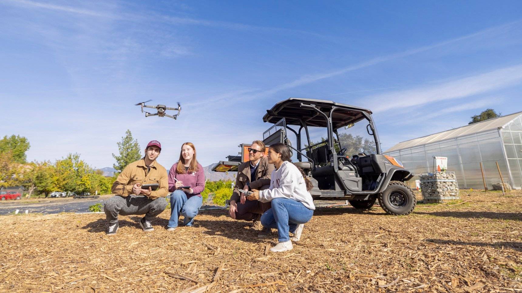 a group of people sitting in front of a drone