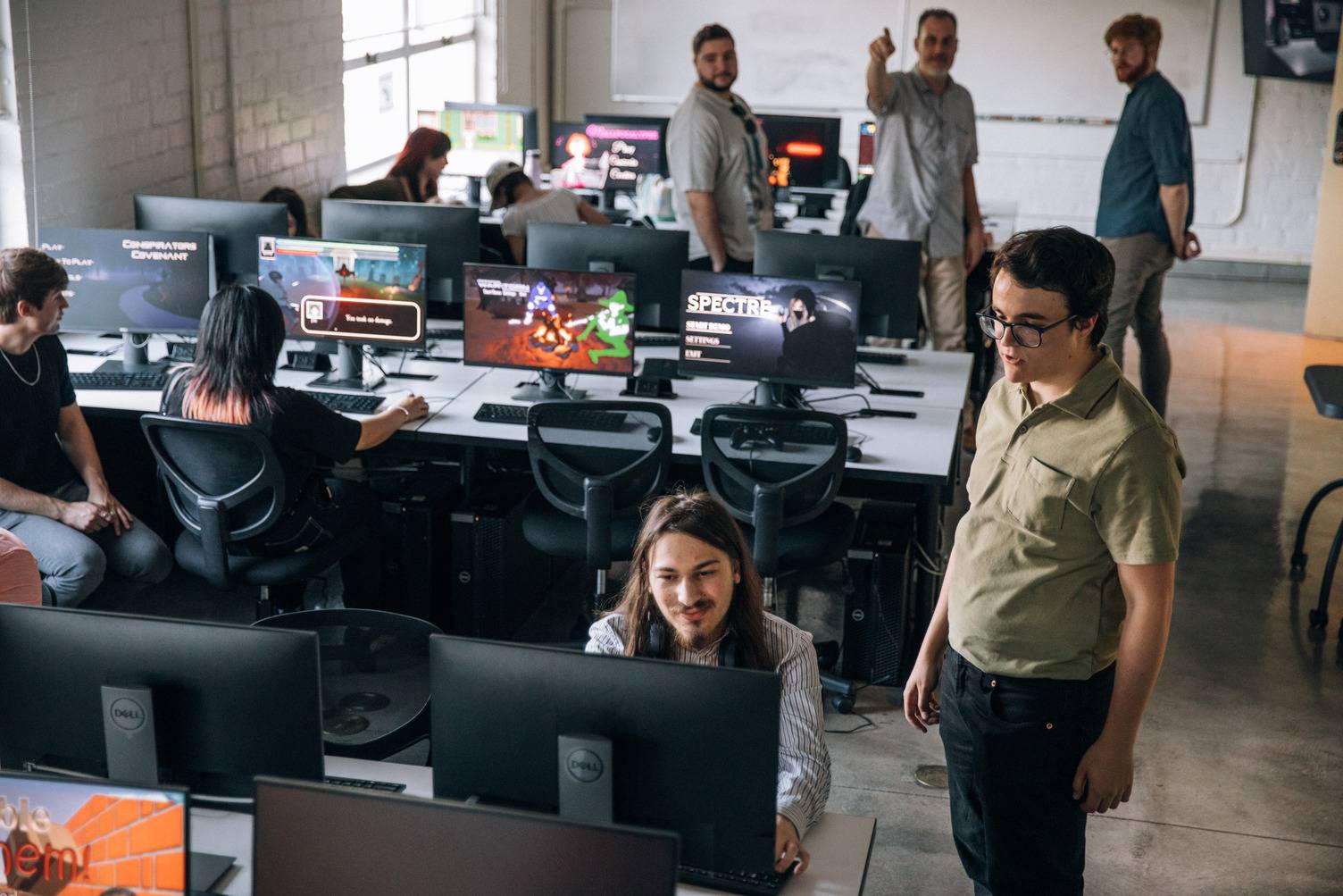 a group of people in a room with computers
