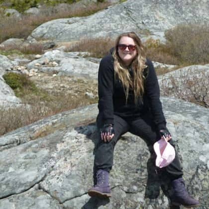 a person sitting on a rock