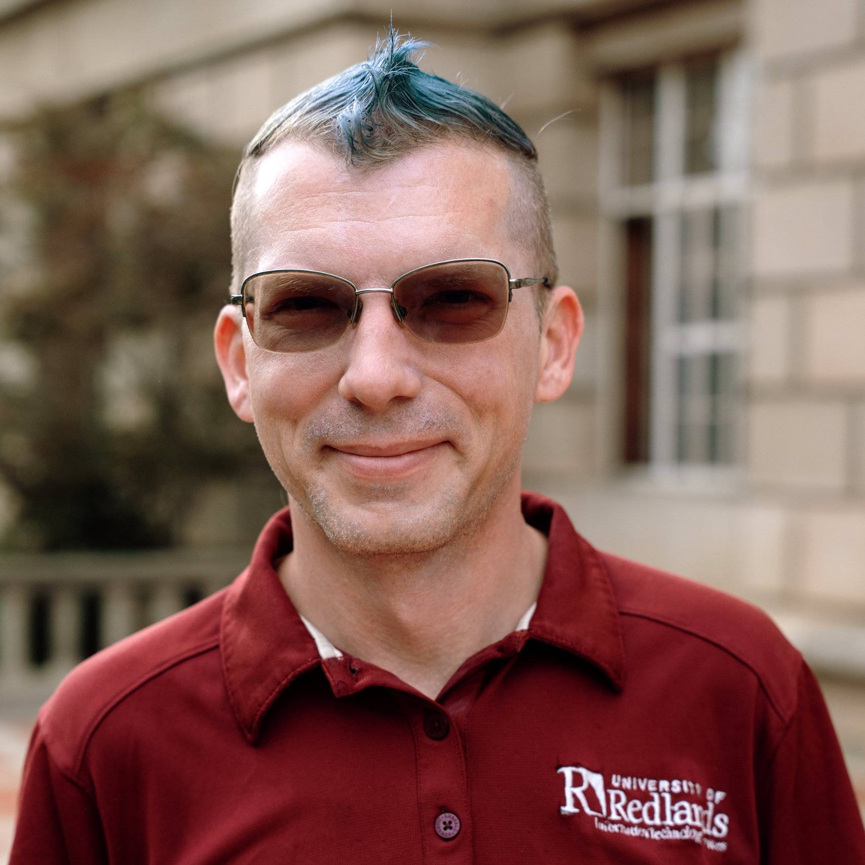 a person with blue hair wearing sunglasses