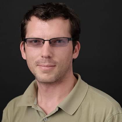 a person wearing glasses and a green shirt