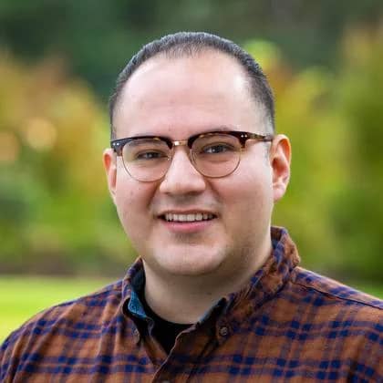 a person wearing glasses and a plaid shirt