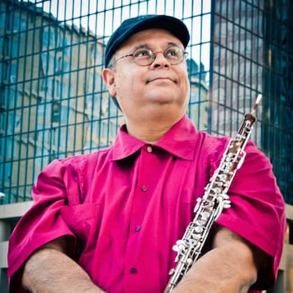 a person in a pink shirt holding a flute