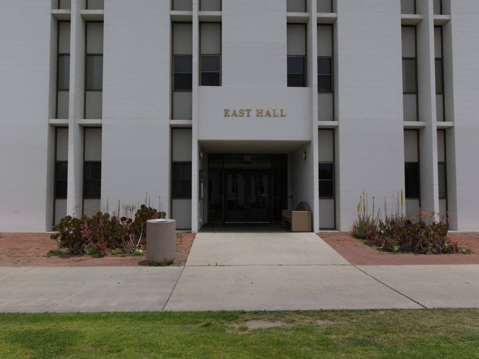 a building with a door and a lawn