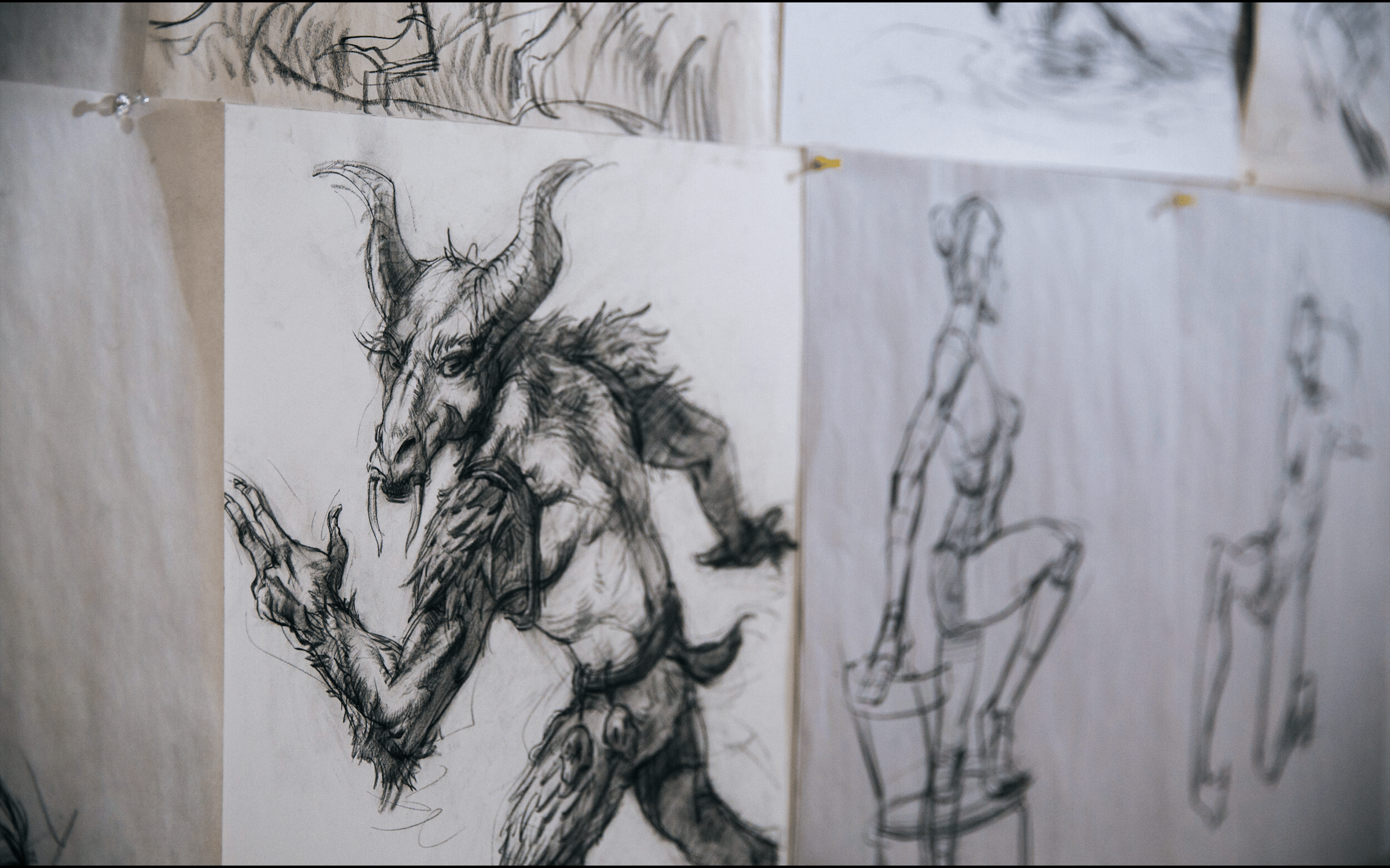 drawings on a wall next to a drawing