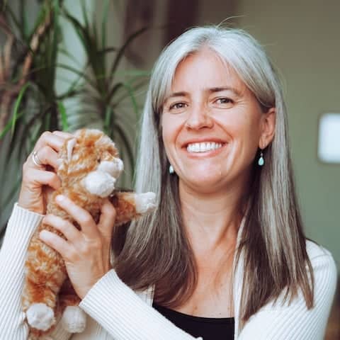 a person holding a stuffed animal
