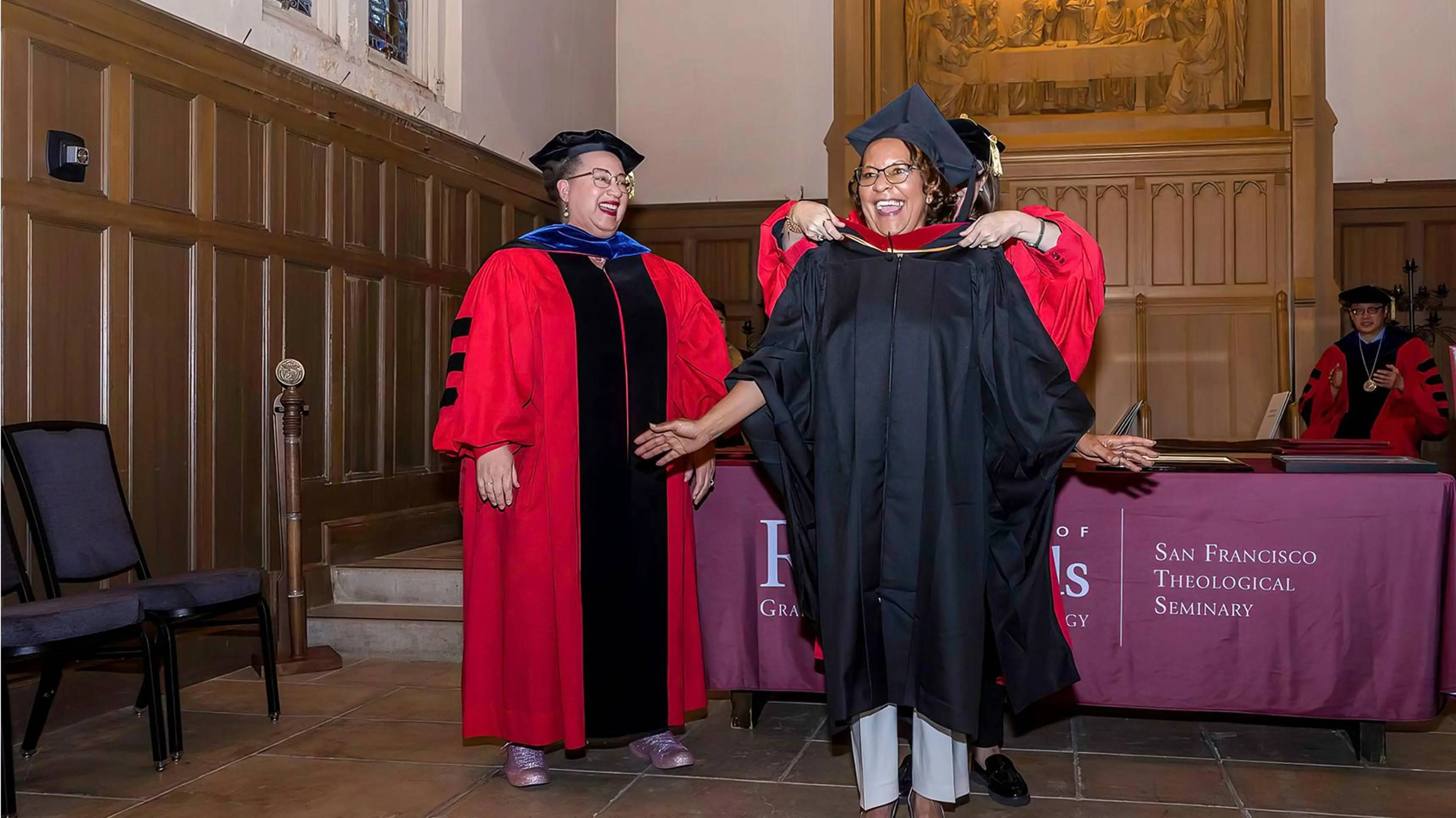 a person in a graduation gown and cap