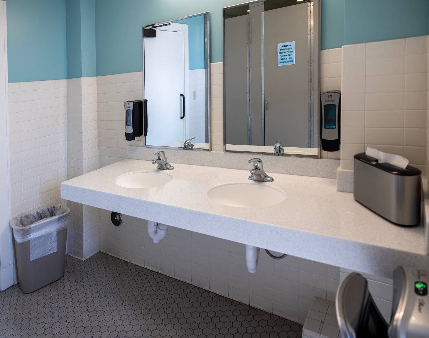 a bathroom with two sinks and mirrors