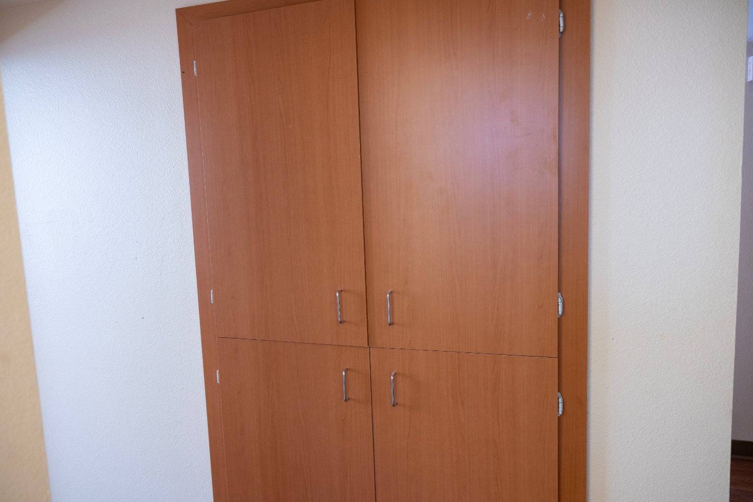a wooden cabinet with handles