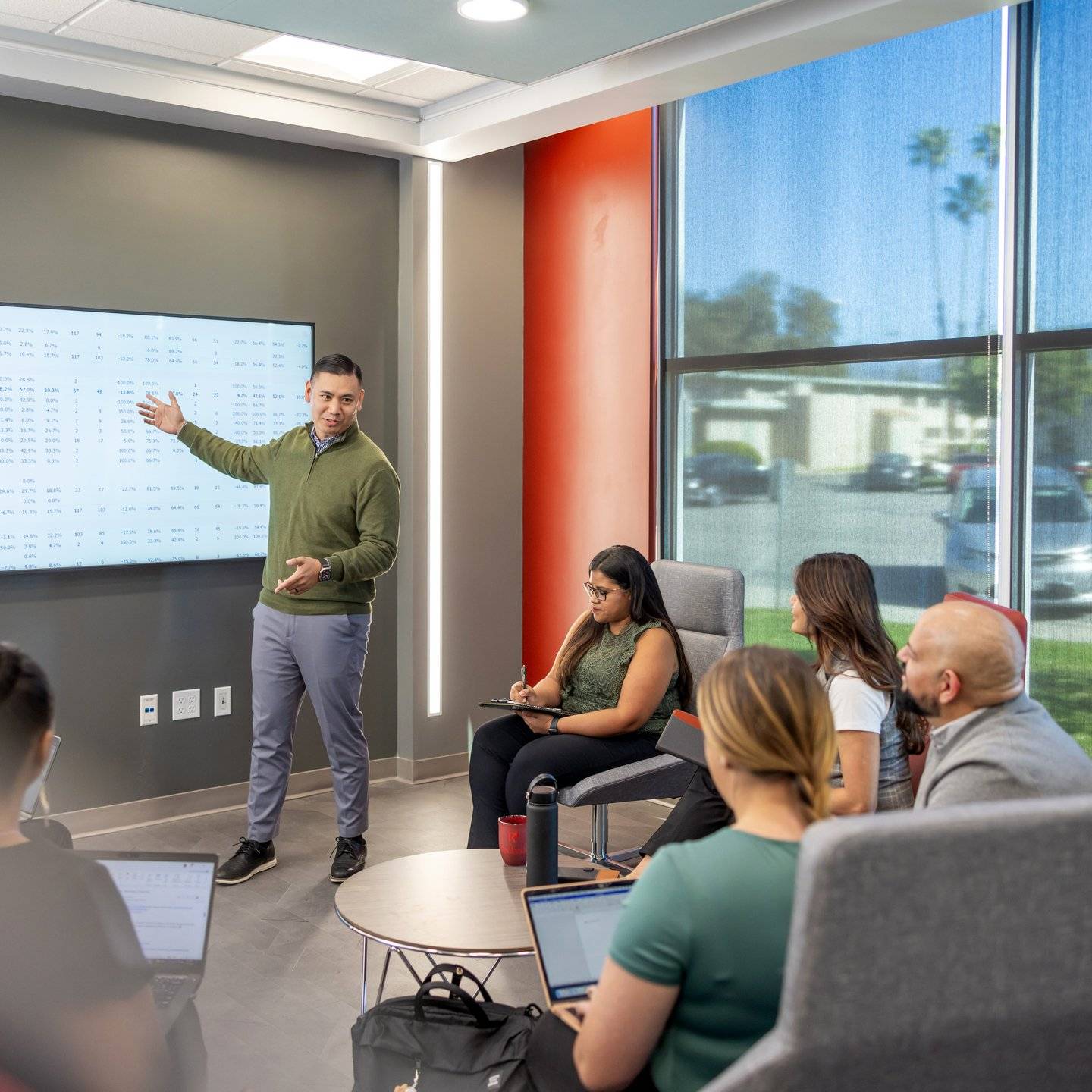 a person standing in front of a large screen