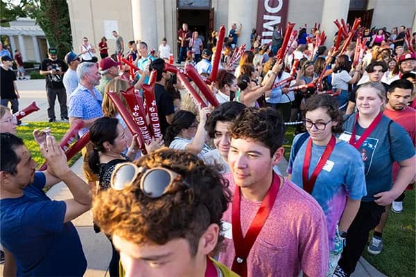 a group of people holding red objects