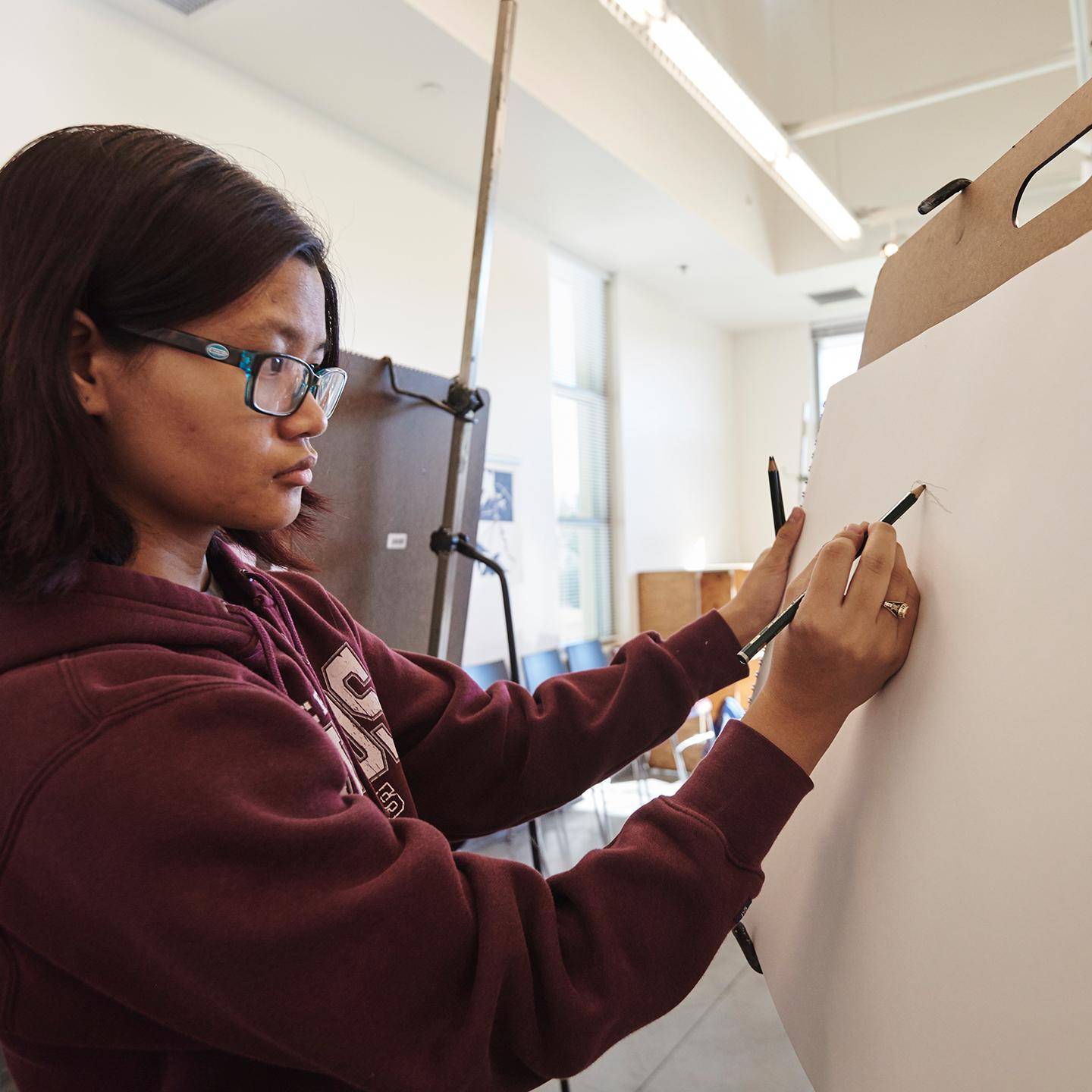 a person drawing on a paper