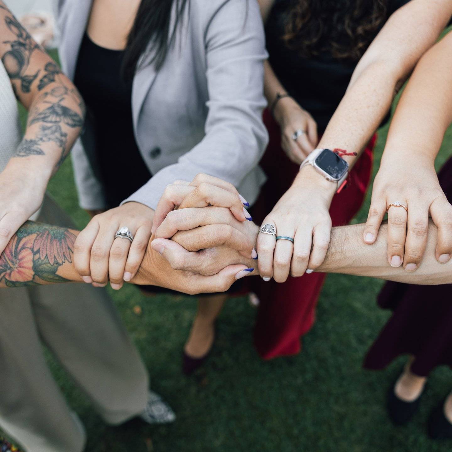 a group of people holding hands together