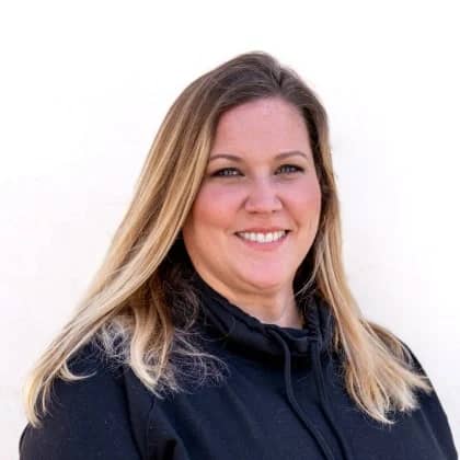 a person with blonde hair smiling