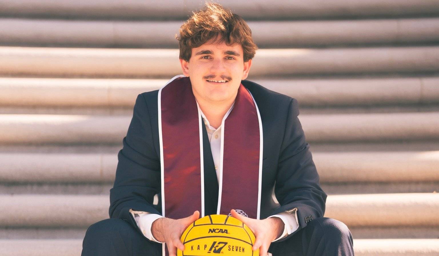 a person in a suit holding a volleyball