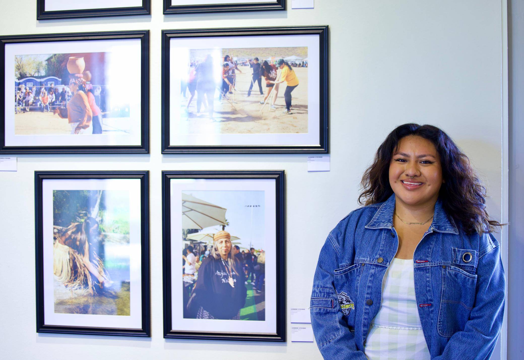 a person standing next to a wall of pictures