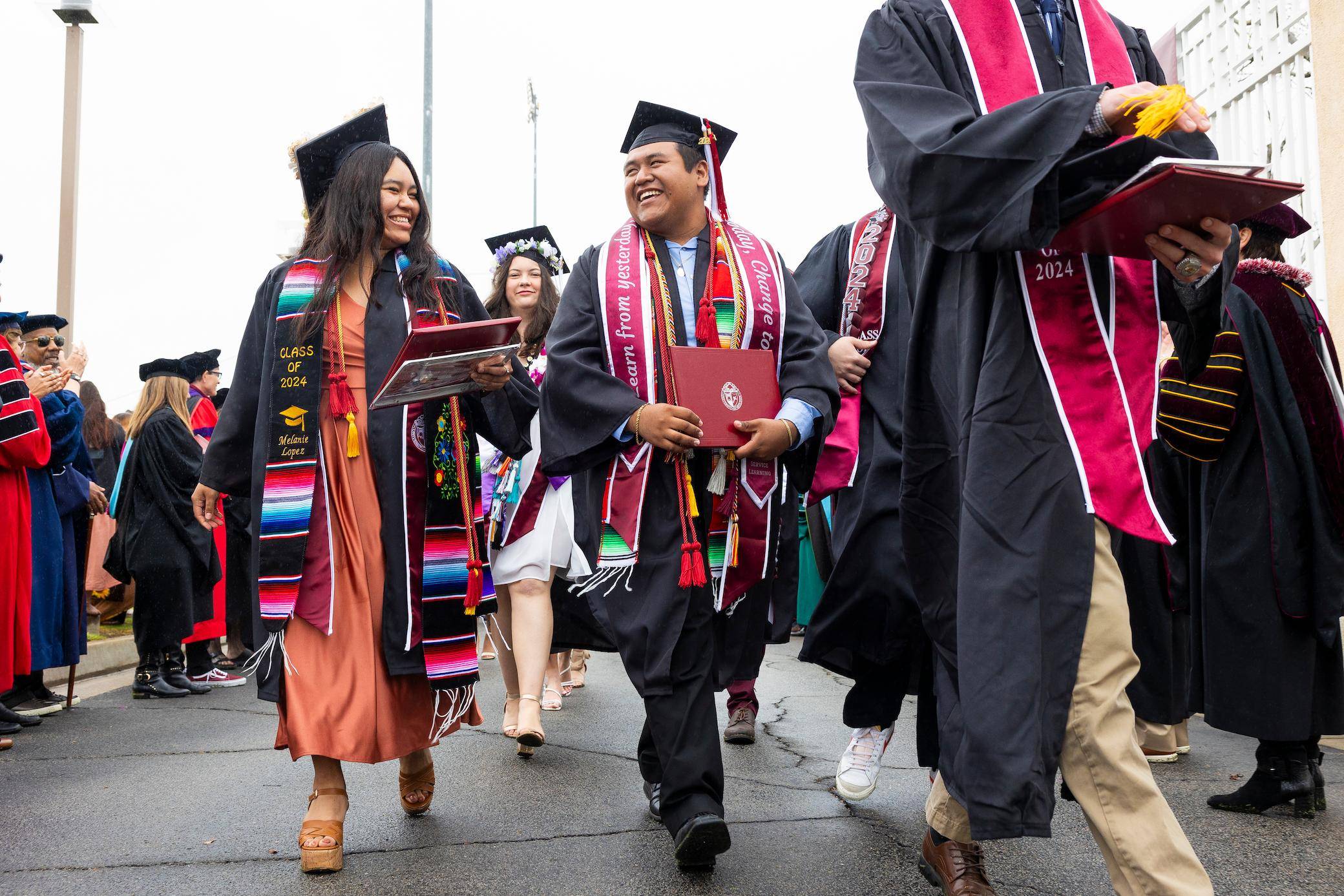 a group of people in graduation gowns and caps