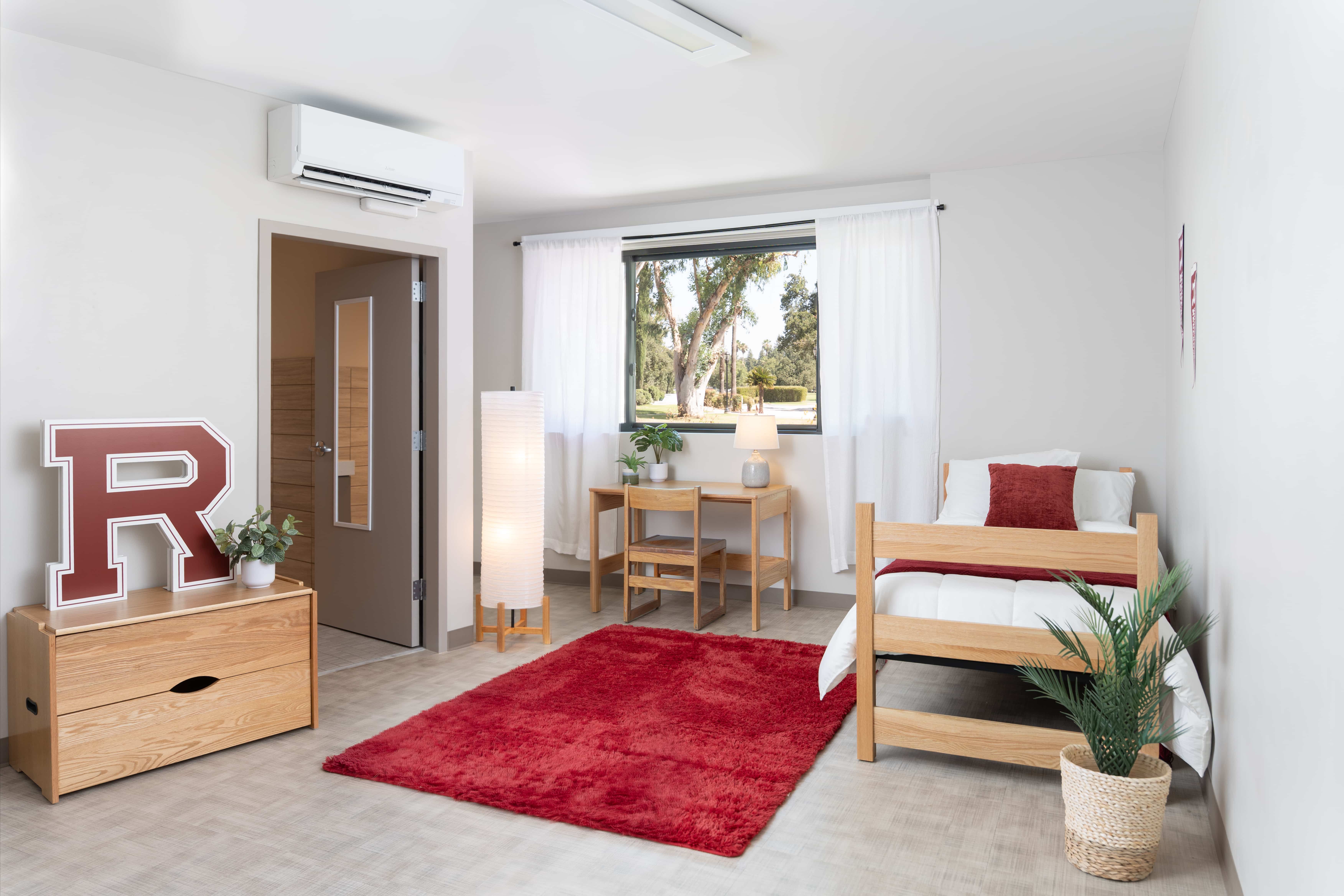 a bedroom with a red rug and a bed