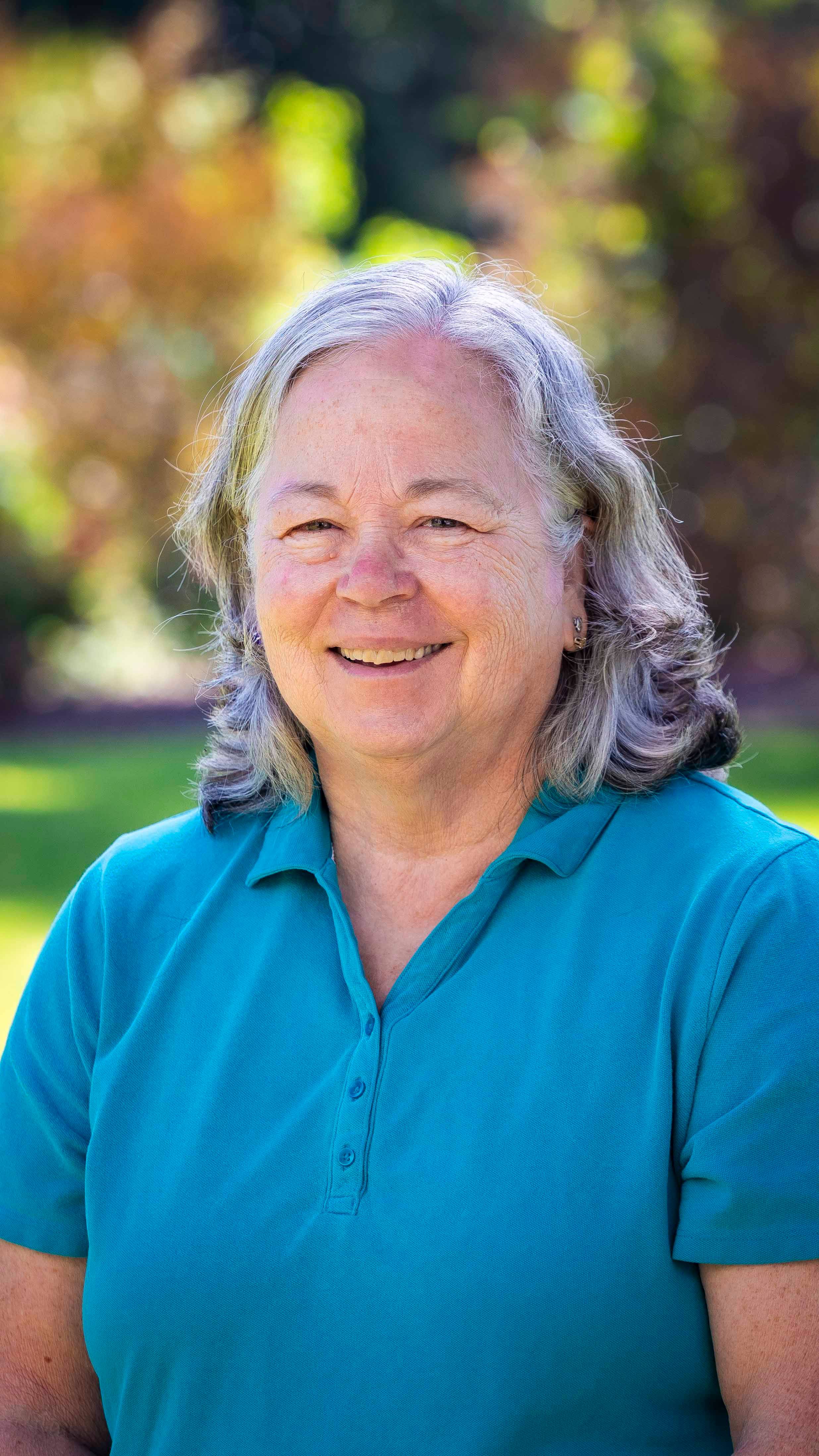 a person with grey hair smiling