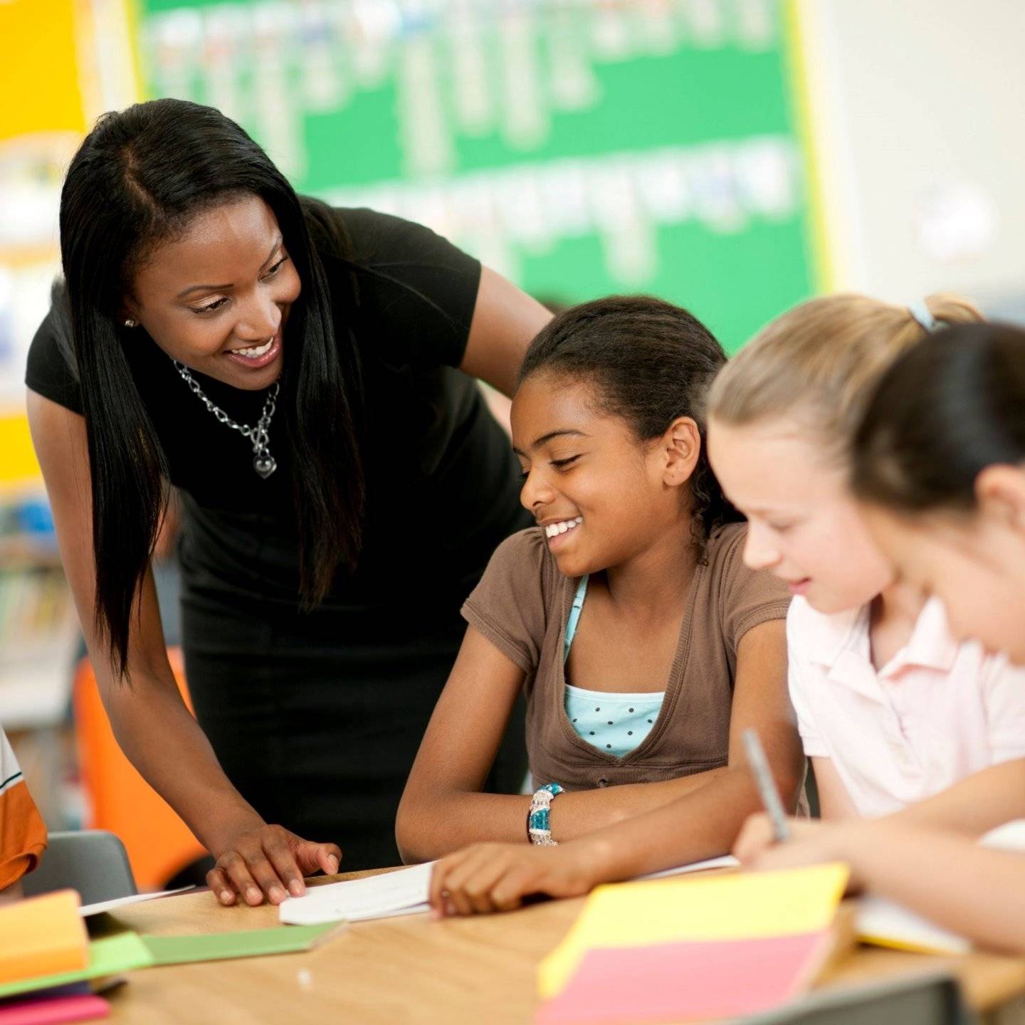 a teacher helping students with their homework