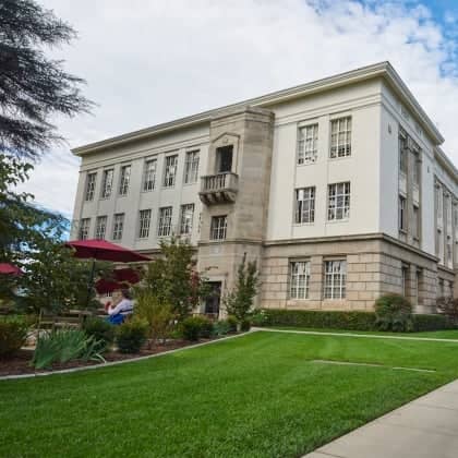 a building with a lawn and a sidewalk