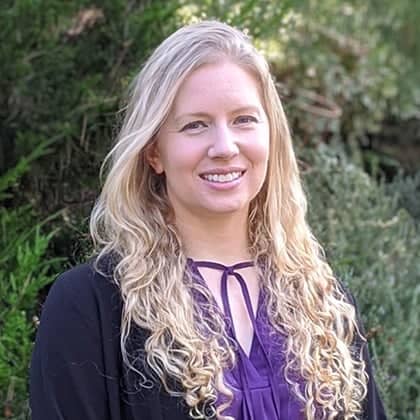 a person with long blonde hair smiling