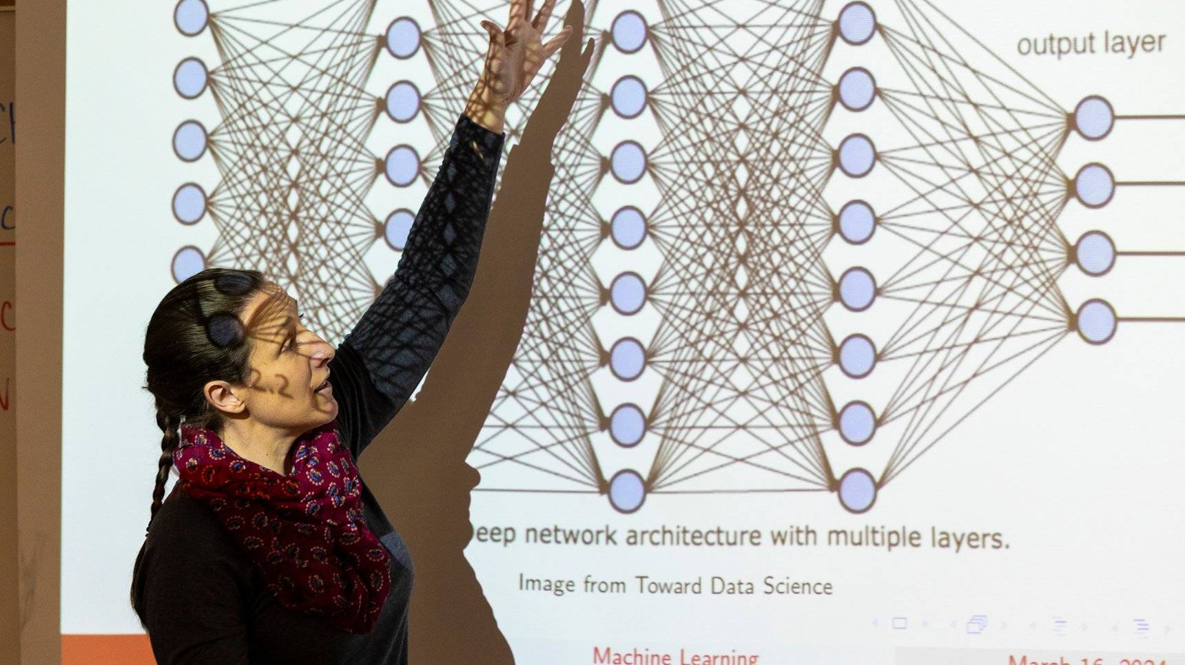 a person standing in front of a projection screen