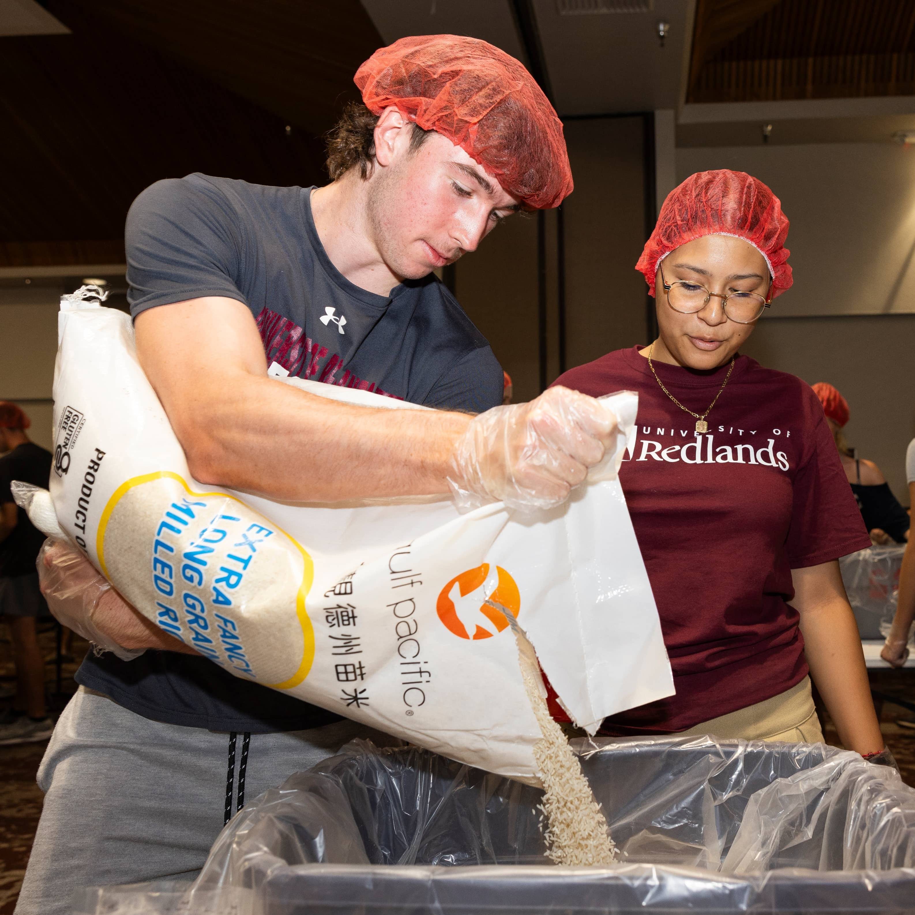 a person and person in red hair and plastic bags pouring rice into a plastic bag