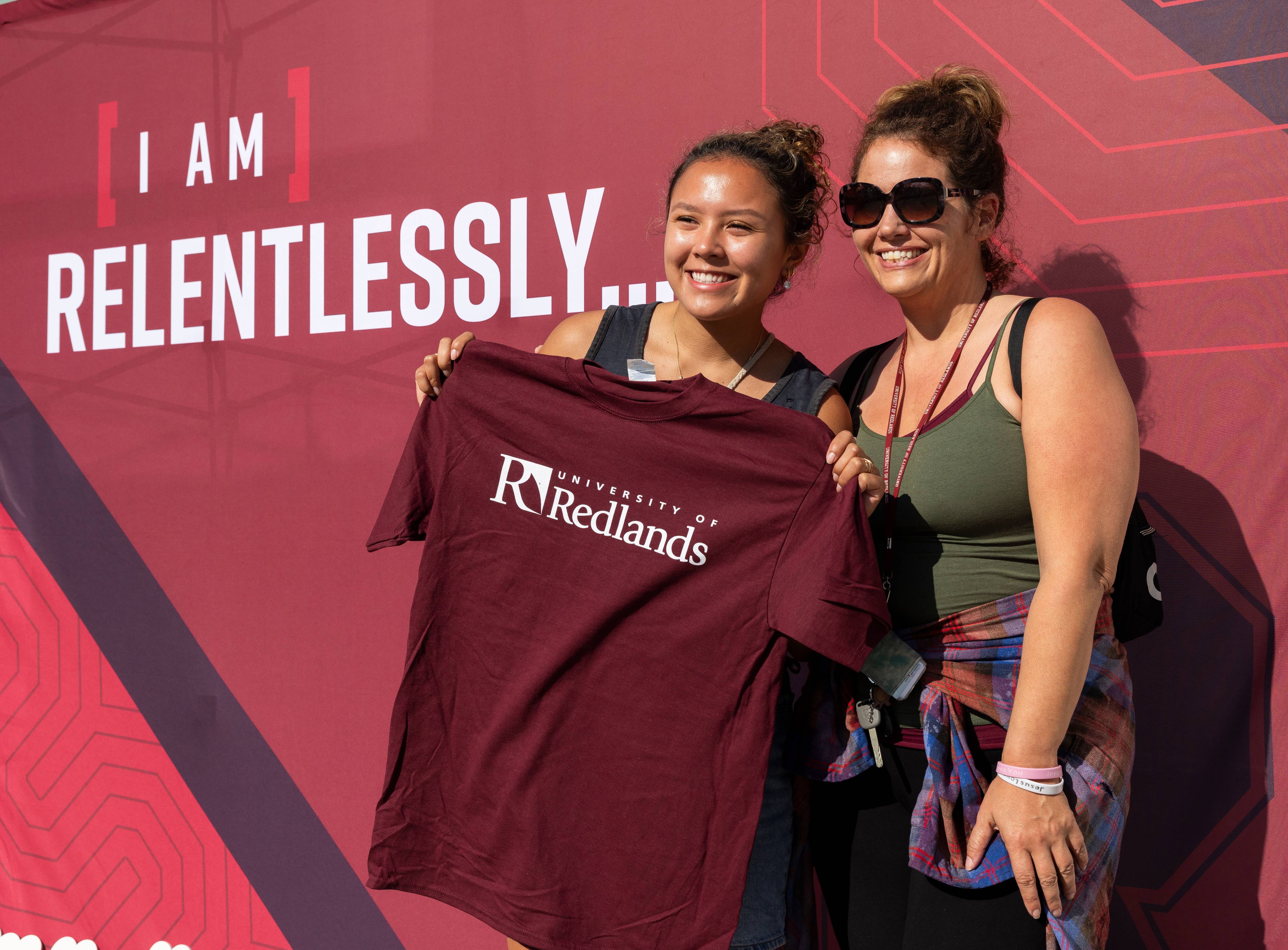 two women holding a shirt