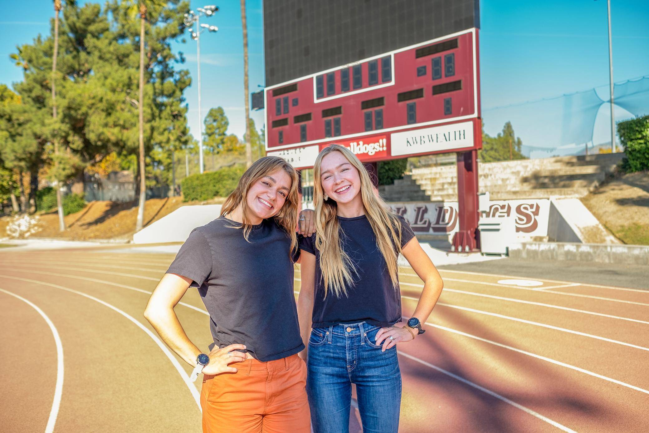two women standing on a track