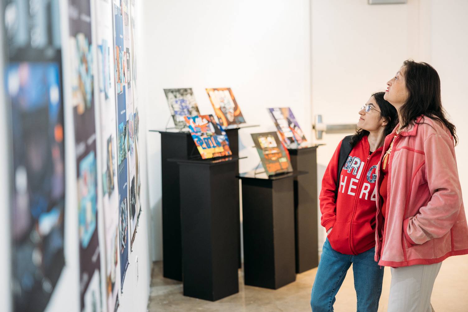 a person looking at a wall with pictures on it