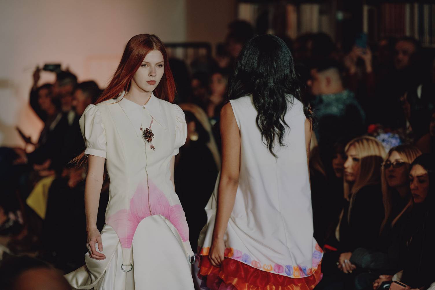 two women walking down the runway