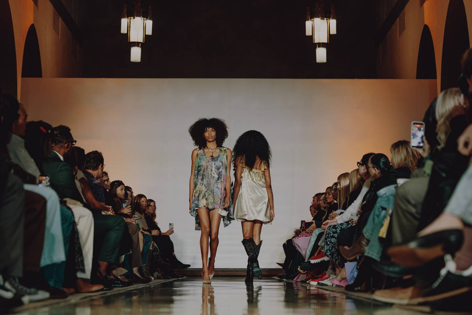 a group of women walking down a runway