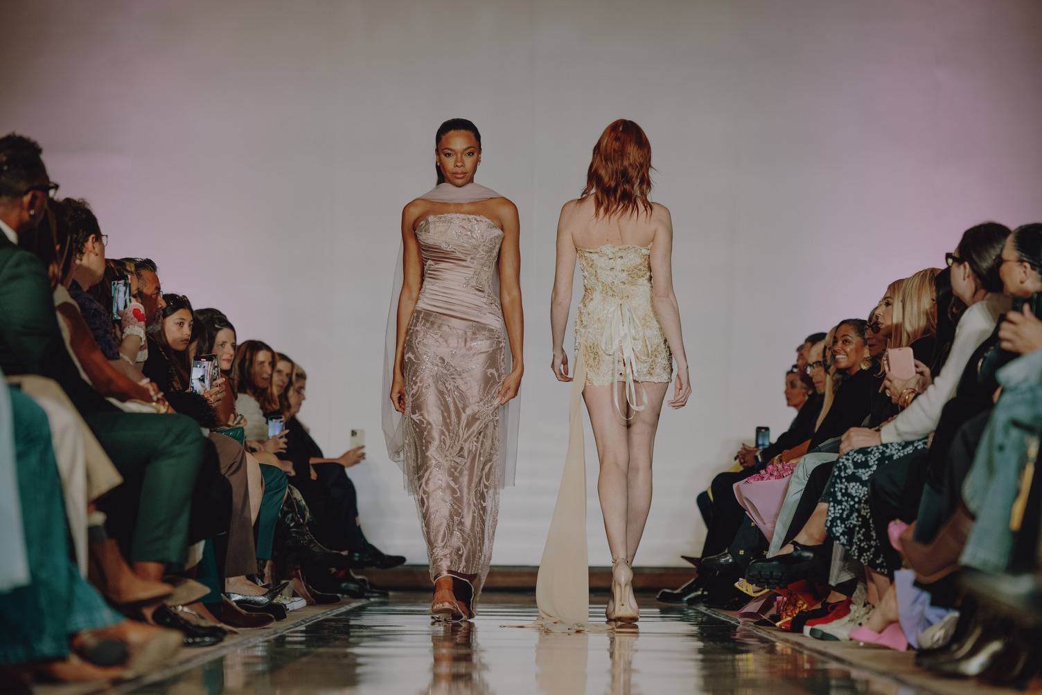 a group of women walking down a runway