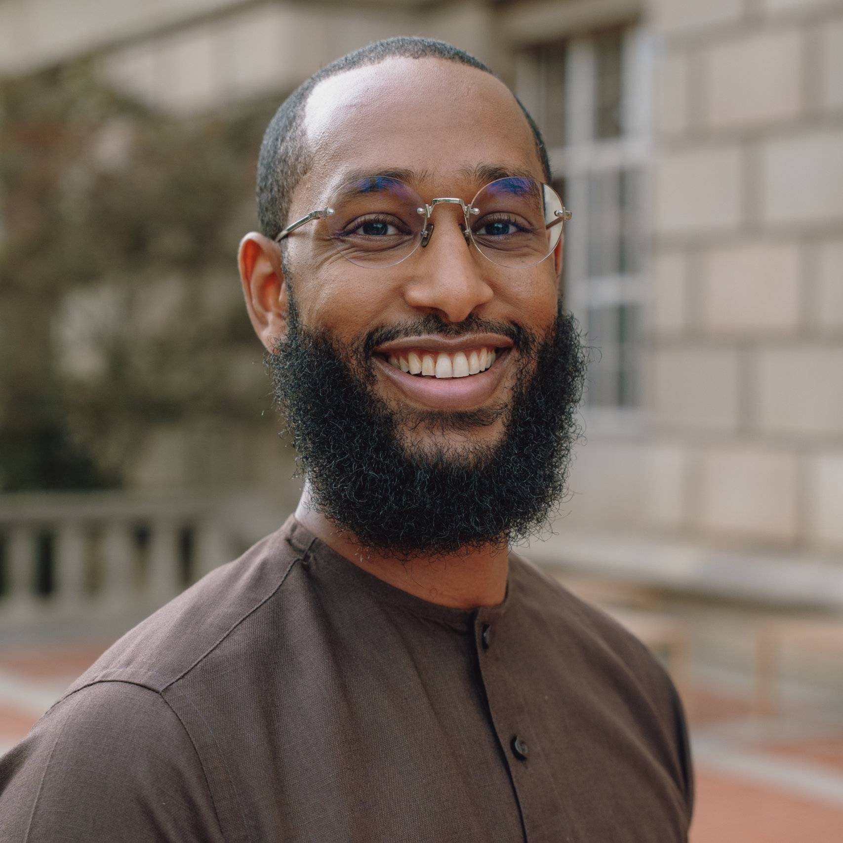 a person with a beard smiling