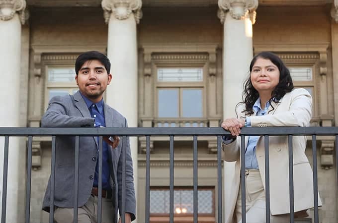 a person and person standing on a railing