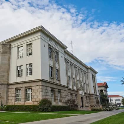 a large building with grass and a lawn