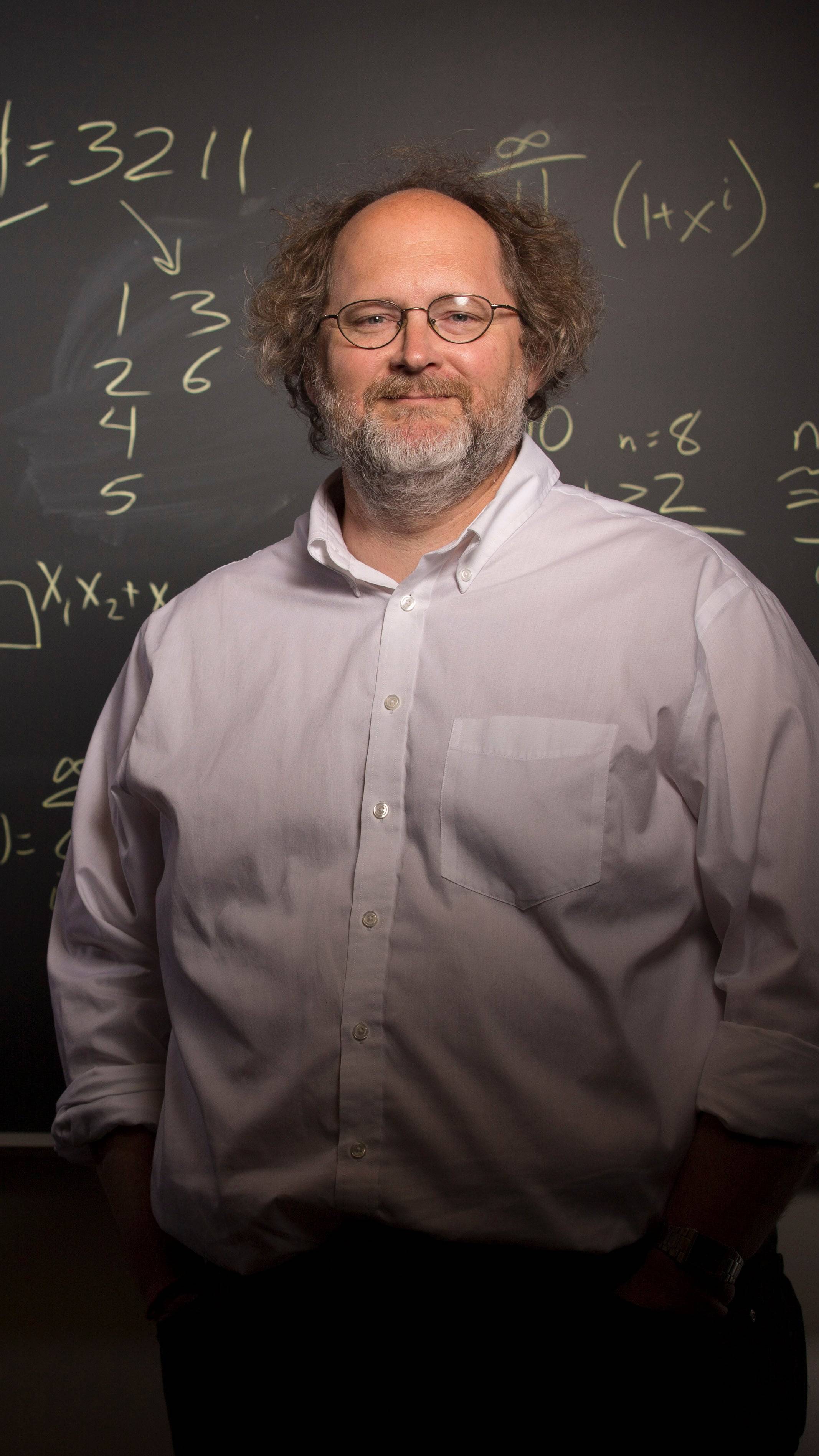 a person standing in front of a chalkboard
