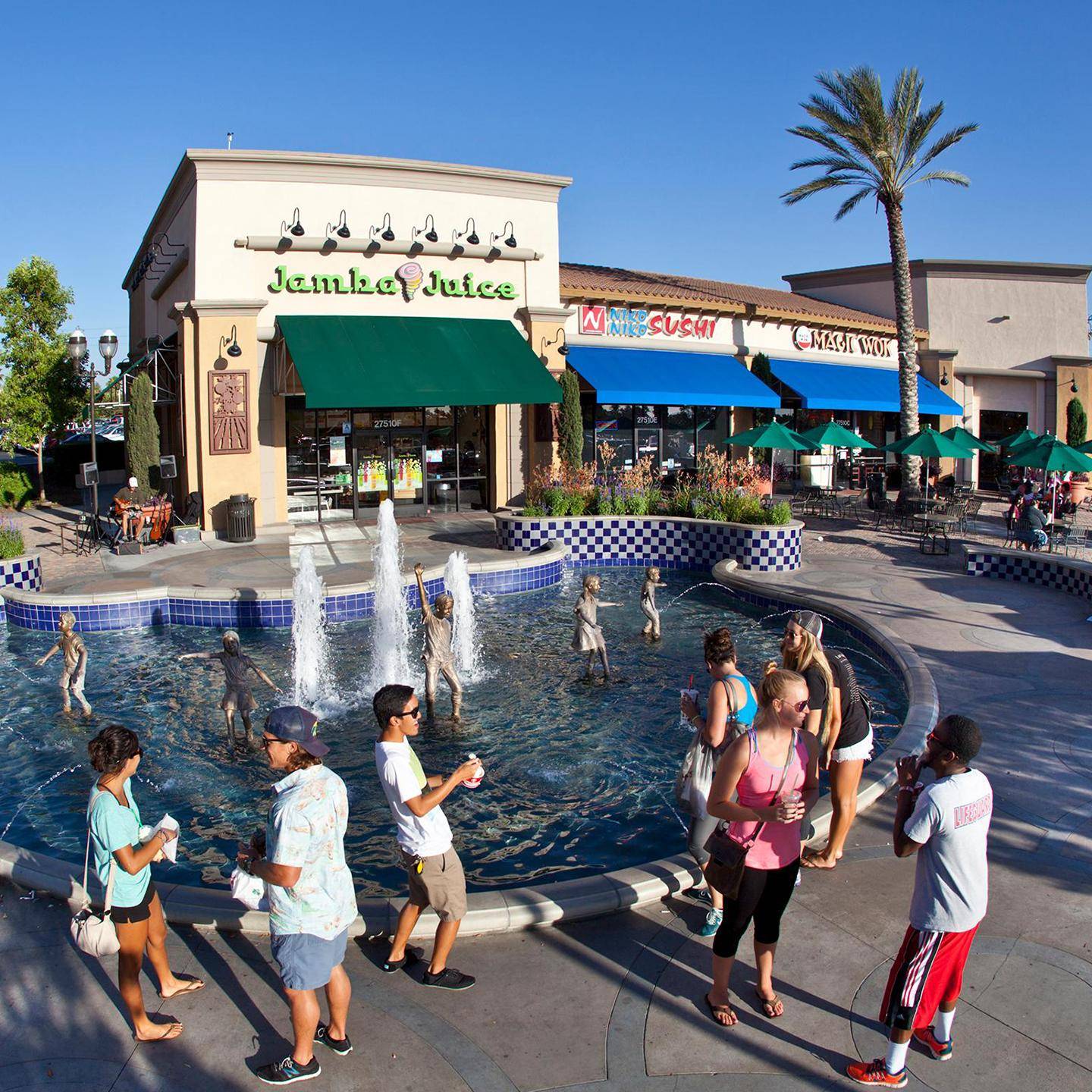 a group of people standing in a fountain
