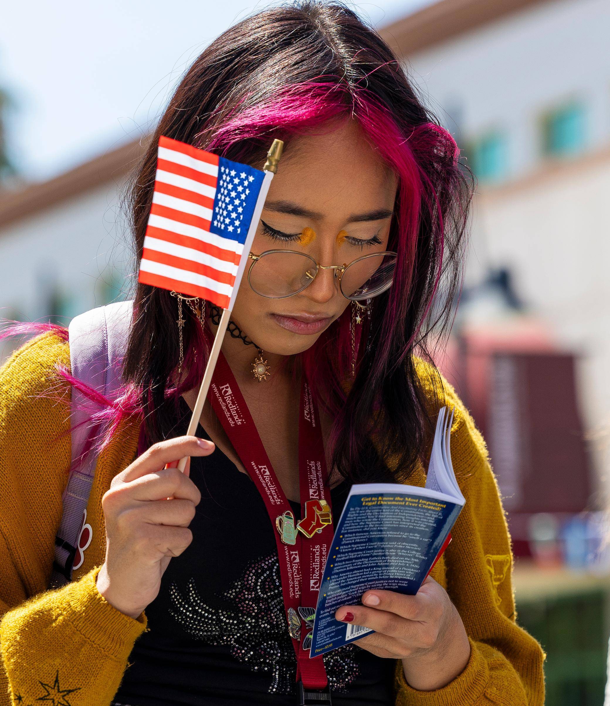 a person holding a flag and a book