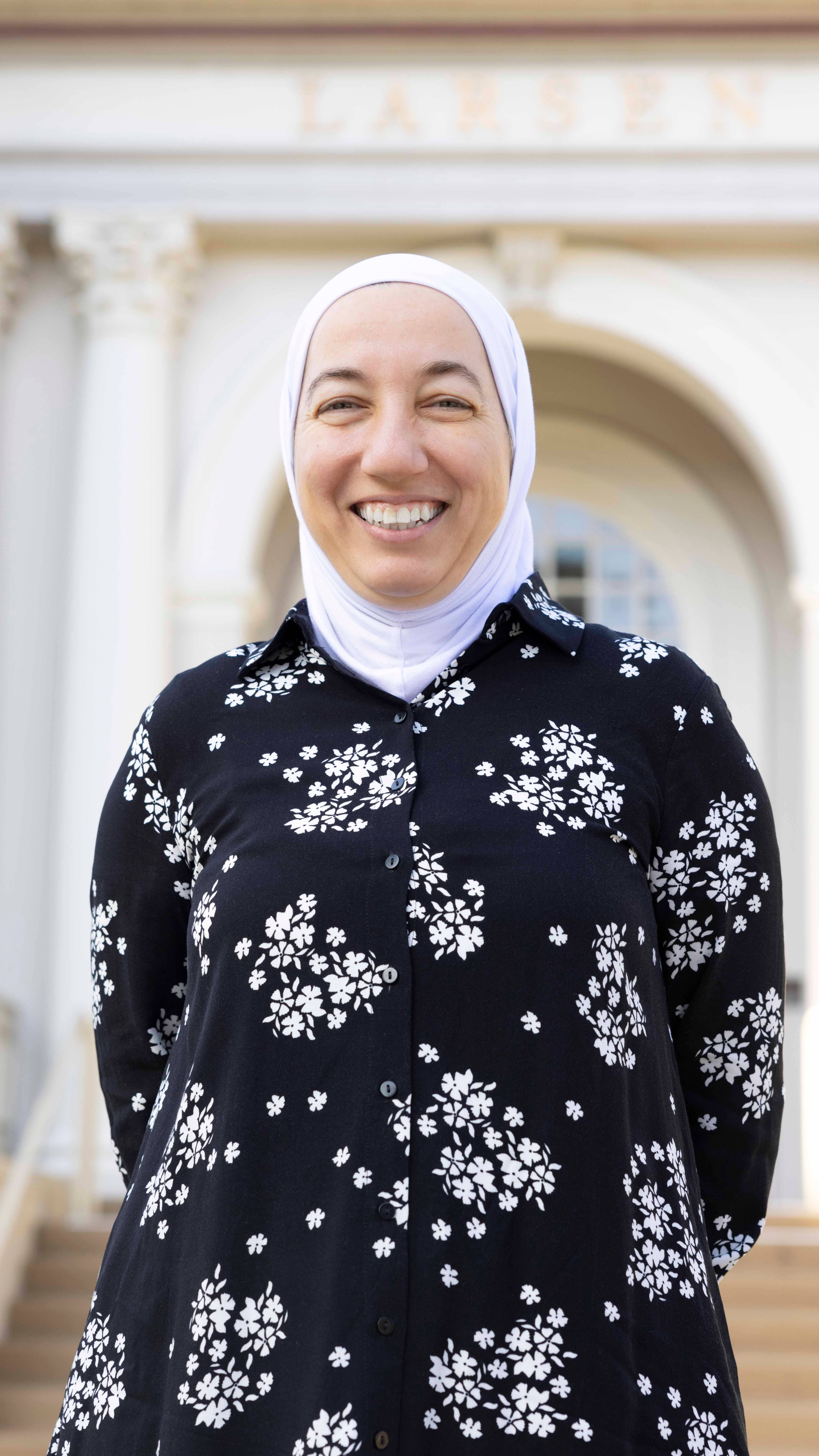 a person wearing a head scarf smiling