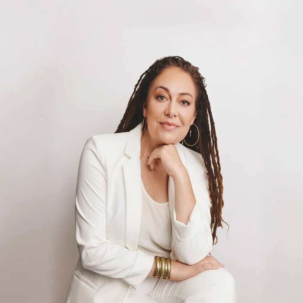 a person in white suit with long dreadlocks