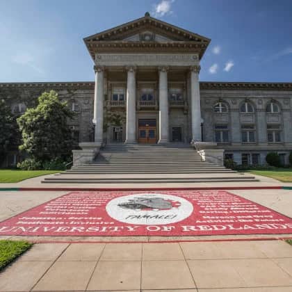 a building with columns and a red carpet
